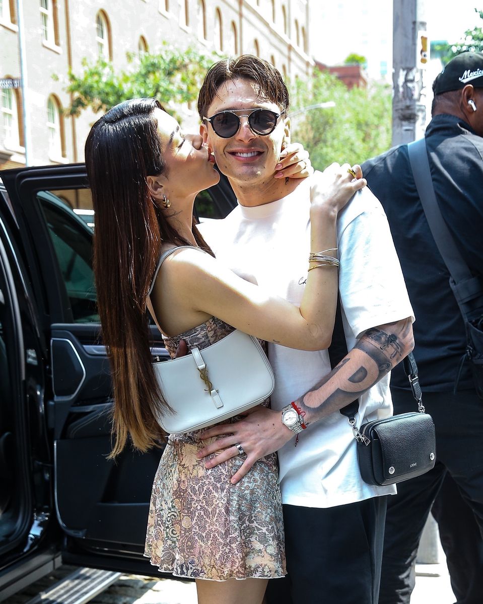 Mexican singer and rapper Peso Pluma and his girlfriend Kenia Os are seen holding hands and kissing in New York.
