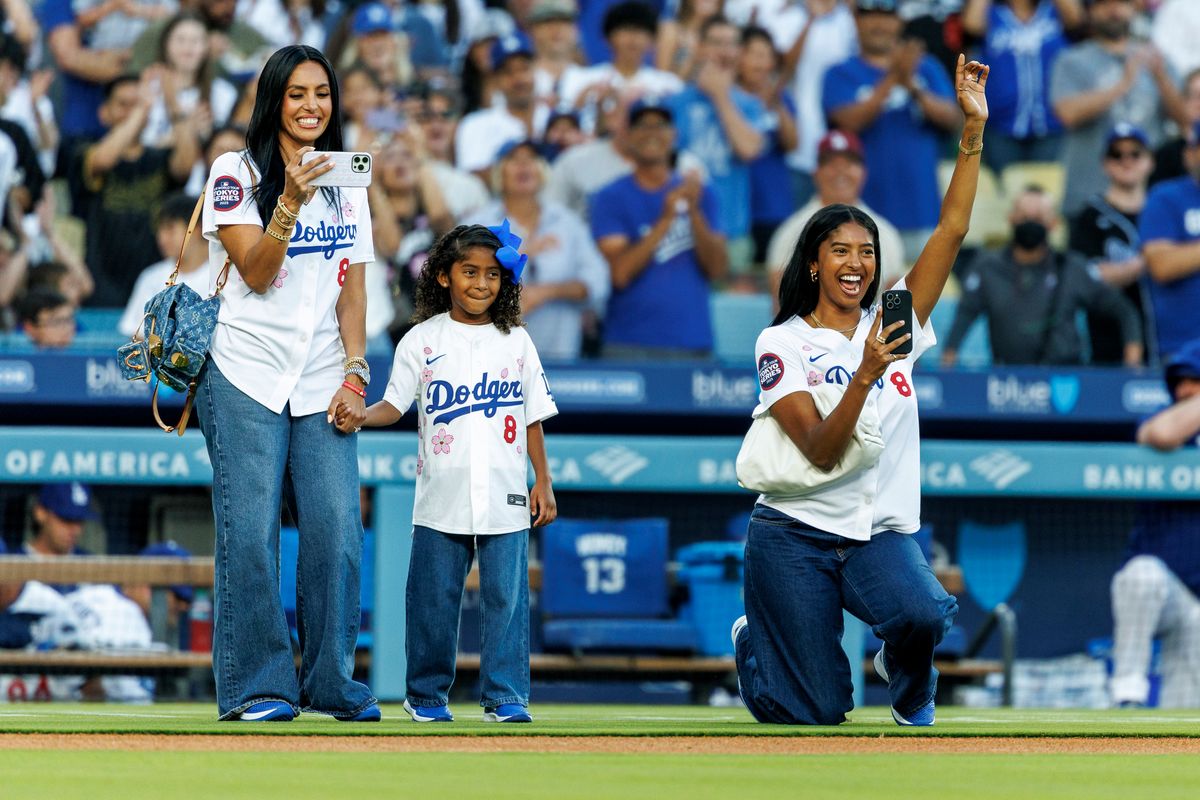 LOS ANGELES, CA - AUGUST 8, 2025: Natalia Bryant, 22, right, with her sister Capri,6, and mom Vanessa cheers as her sister Bianka, 8, throws out the first pitch before the game against the Toronto Blue Jays on Kobe Bryant bobble head night at Dodger Stadium on August 8, 2025 in Los Angeles, California.(Gina Ferazzi / Los Angeles Times via Getty Images) 