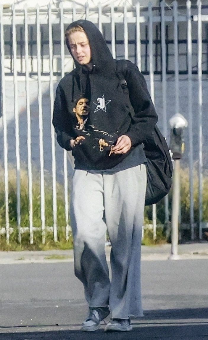 Shiloh Jolie was seen leaving a dance class, keeping a low profile in a black hoodie featuring a graphic print of a scene from Scarface.