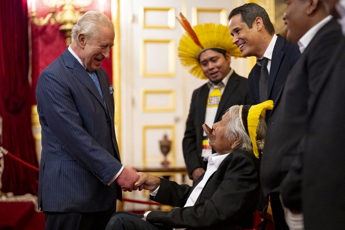 King Charles III greets Kayapo Chief Raoni Metuktire, indigenous Brazilian leader and environmentalist, during a reception for scientists and business and indigenous leaders with the Circular Bioeconomy Alliance at St James's Palace