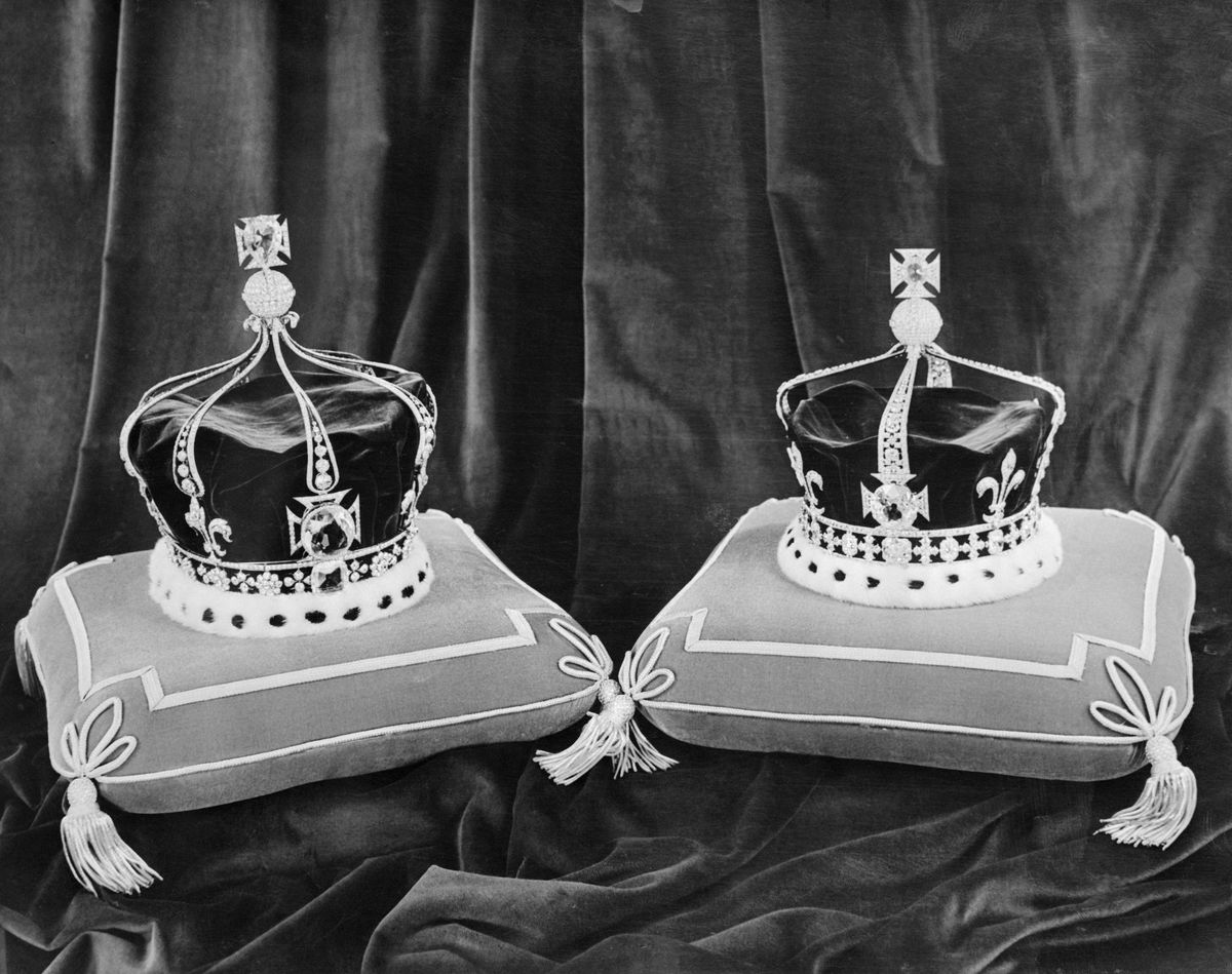 Queen Mary's crown (on the left), which has four crosses and four fleur-de-lis and contains in front the Koh-in-noor diamond, and Queen Elizabeth, The Queen Mother's crown (on the right).