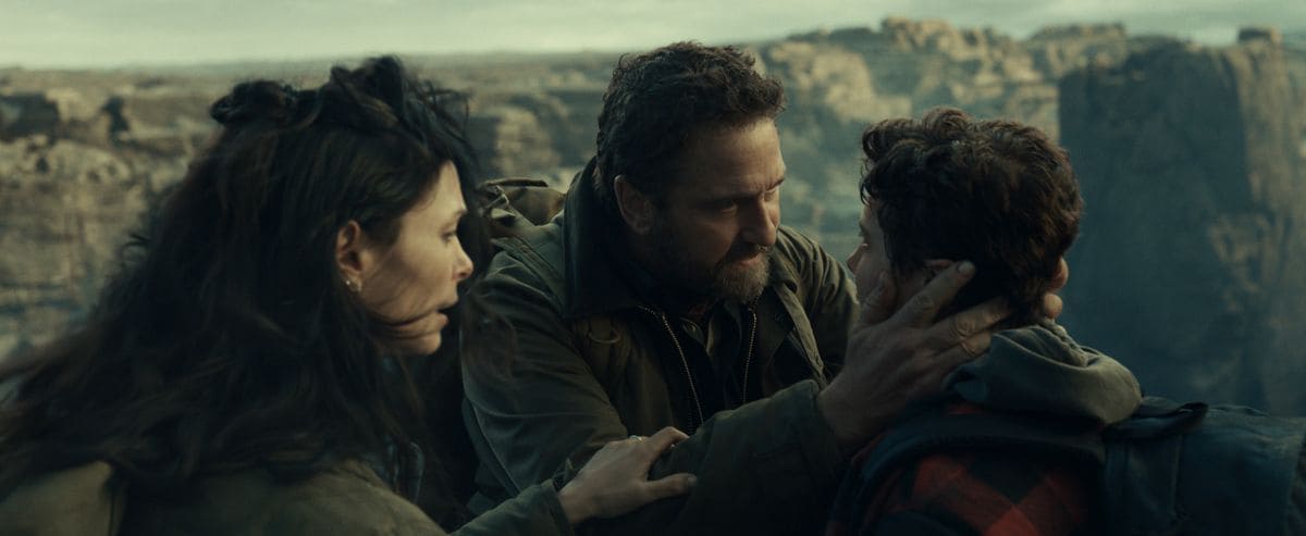 Morena Baccarin as Allison Garrity, Gerard Butler as John Garrity and Roman Griffin Davis as Nathan Garrity in Greenland 2: Migration