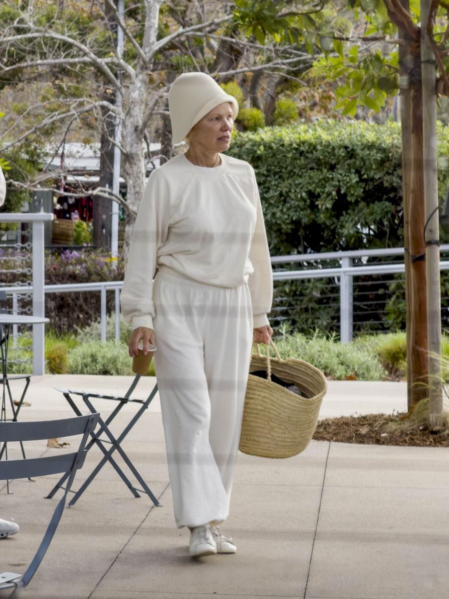 Pamela Anderson looks unrecognizable as she goes makeup-free in all-white look and bold hat