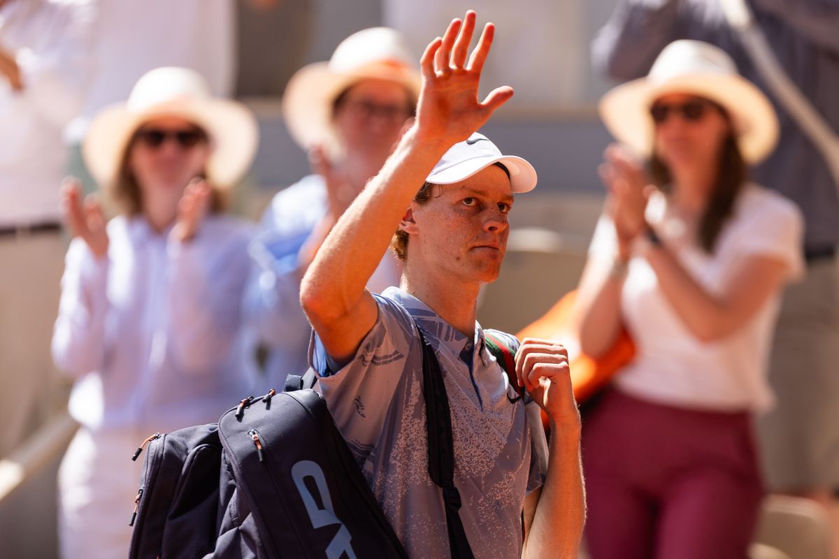 Jannik Sinner waves as he leaves the court after losing his men's singles match against Juan Manuel Cerundolo