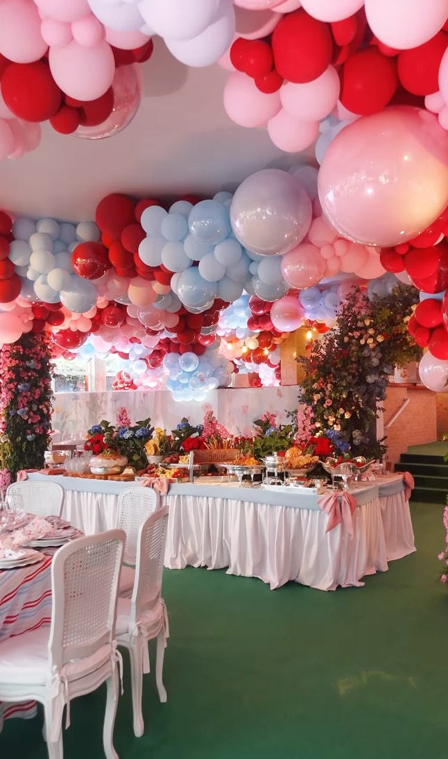 Tables were covered in floral prints, balloons cascaded from the ceiling in pastel shades of pink, blue, and red.