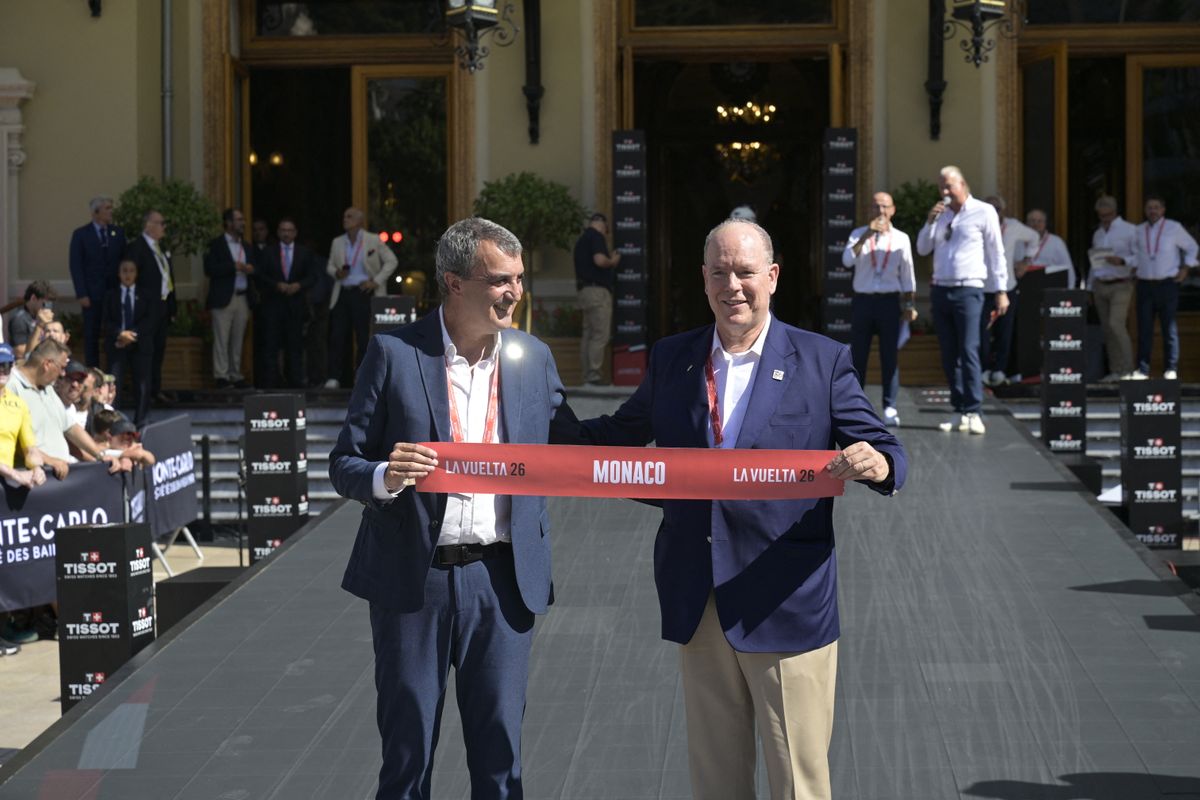 Prince Albert II of Monaco and La Vuelta director Javier Guillén hold the ceremonial ribbon as Monaco marks the start of La Vuelta 2026 on August 22, 2026.