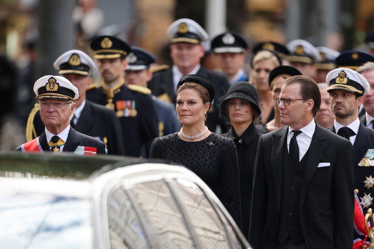 King Carl Gustaf and Crown Princess Victoria of Sweden join the solemn procession honoring King Harald V.