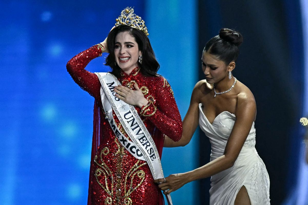 Miss Mexico Fatima Bosch (L) celebrates winning the 2025 Miss Universe pageant in Nonthaburi, north of Bangkok, on November 21, 2025. (Photo by Lillian SUWANRUMPHA / AFP) (Photo by LILLIAN SUWANRUMPHA/AFP via Getty Images)           
