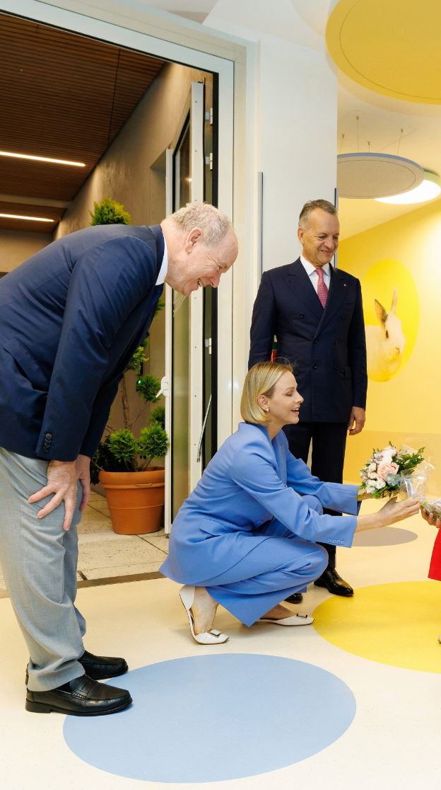 Princess Charlene paired her blue trouser suit with an ivory top and white buckle flats for the inauguration of Monaco’s Ida nursery.