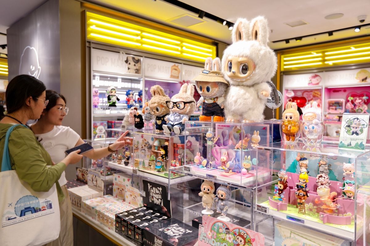 Customers select Labubu figures at a Pop Mart store on June 9, 2025 in Shanghai, China. From Southeast Asia and Europe to the United States and the Middle East, Labubu - the beloved character from Chinese toy company Pop Mart - is taking the world by storm. (Photo by VCG/VCG via Getty Images)