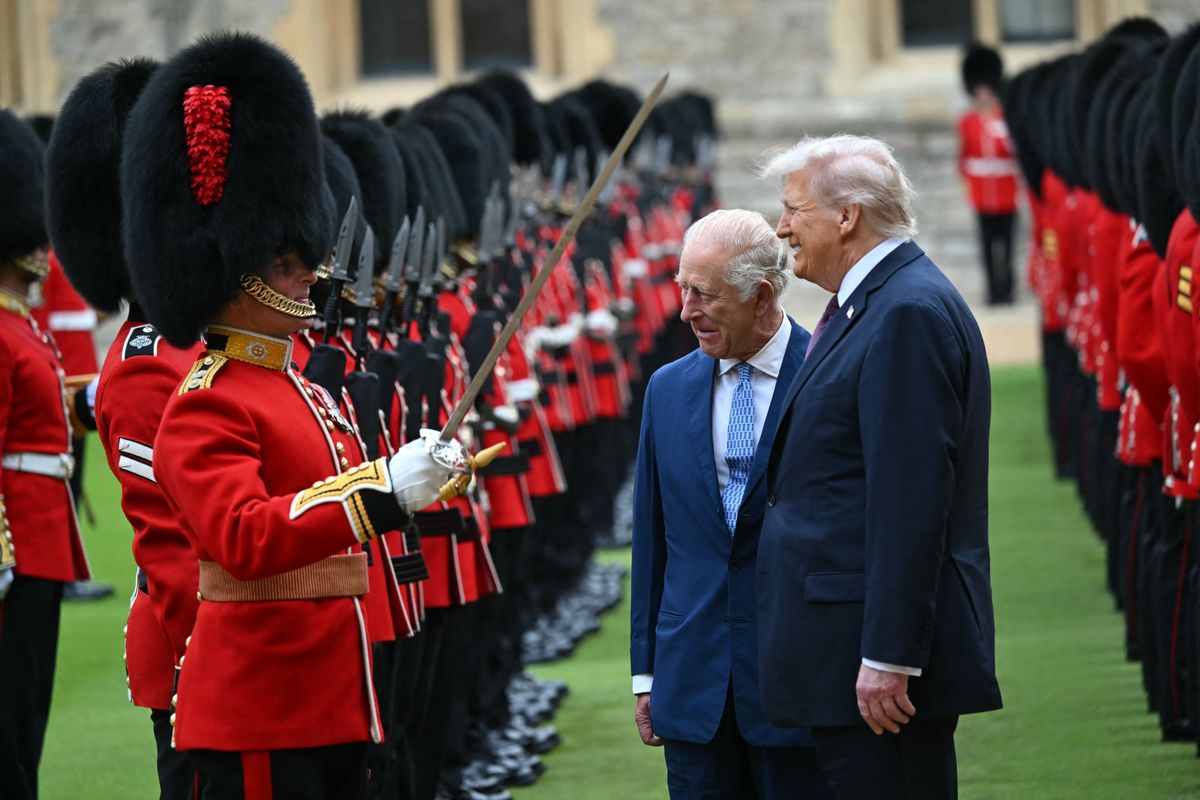 TOPSHOT - Britain's King Charles III (C) and US President Donald Trump (R) talk with a Coldstream Guardsman as they inspect the guard of honour during a ceremonial welcome in the Quadrangle at Windsor Castle, in Windsor, on September 17, 2025, during the US president's second State Visit. US President Donald Trump arrived in Britain for an unprecedented second State Visit, with the UK government rolling out a royal red carpet welcome to win over the mercurial leader. (Photo by ANDREW CABALLERO-REYNOLDS / AFP) (Photo by ANDREW CABALLERO-REYNOLDS/AFP via Getty Images)          