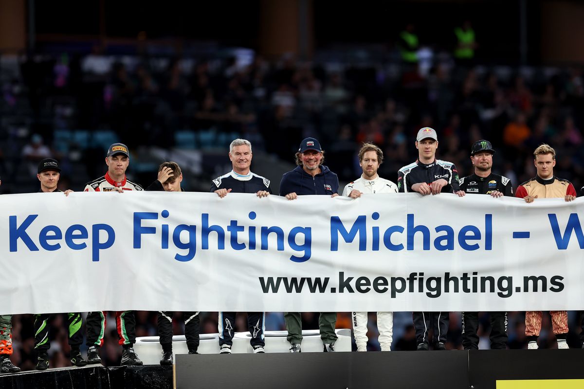 David Coulthard of Great Britain, Kurt Busch of the United States, Sebastian Vettel of Germany and Mick Schumacher of Germany hold a banner in support of Michael Schumacher during the Race of Champions at Accor Stadium on March 08, 2025 in Sydney, Australia. 