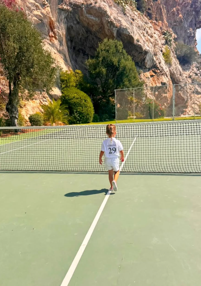 Athena took to the tennis court in an adorable personalized outfit as her mother documented their summer together.