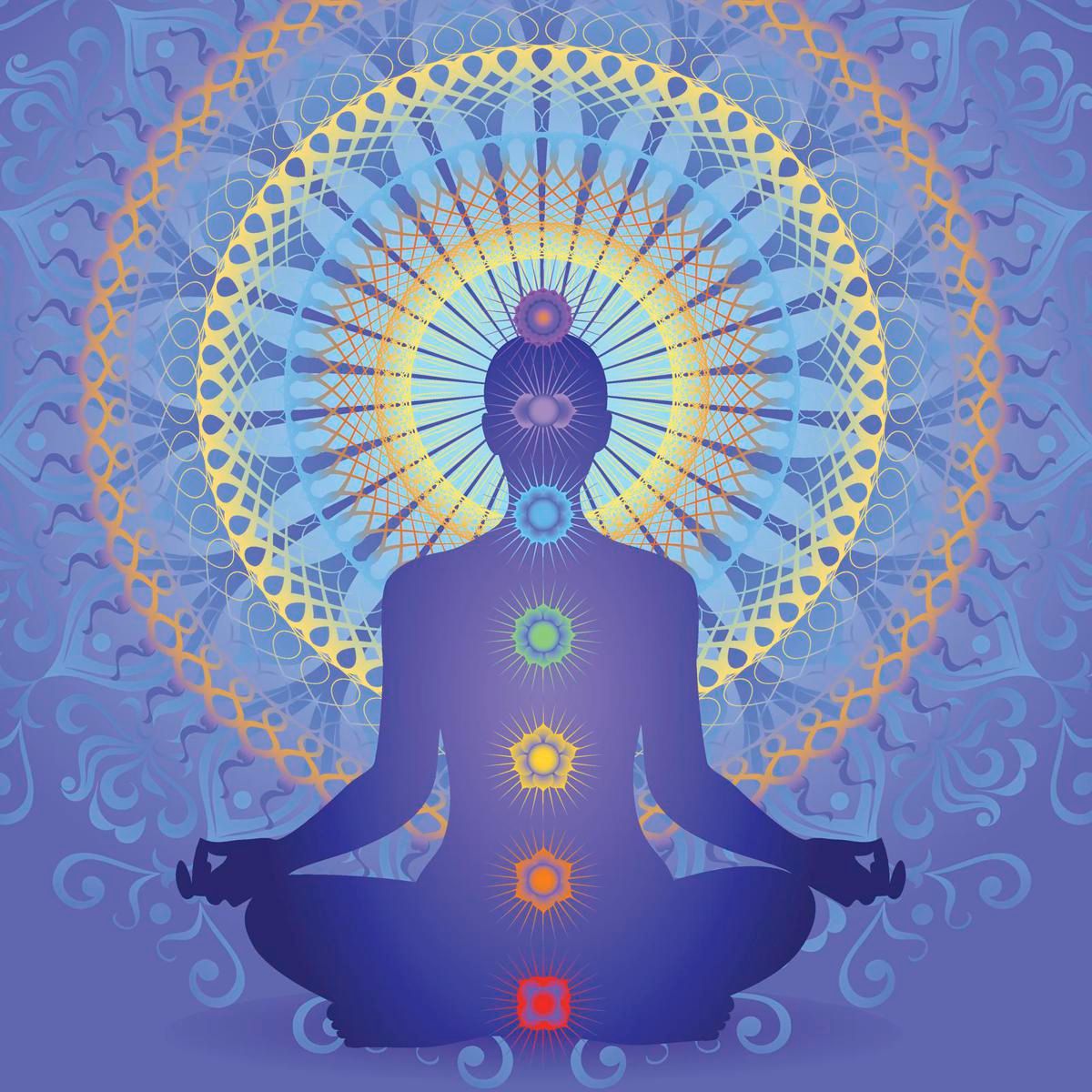 A person sits in meditation with large mandala behind them, chakras visible.