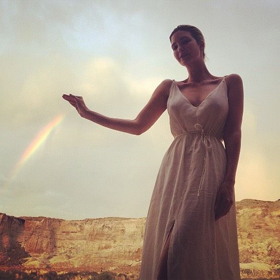 Ivanka posed in a white cinched dress, her hair pulled back in a simple yet stylish bun, with a fresh, no-makeup look