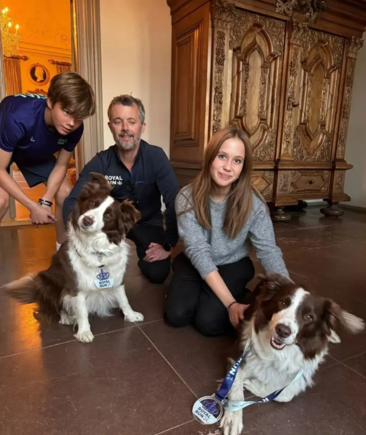 King Frederik and Queen Mary share a family moment with their children and beloved dogs.