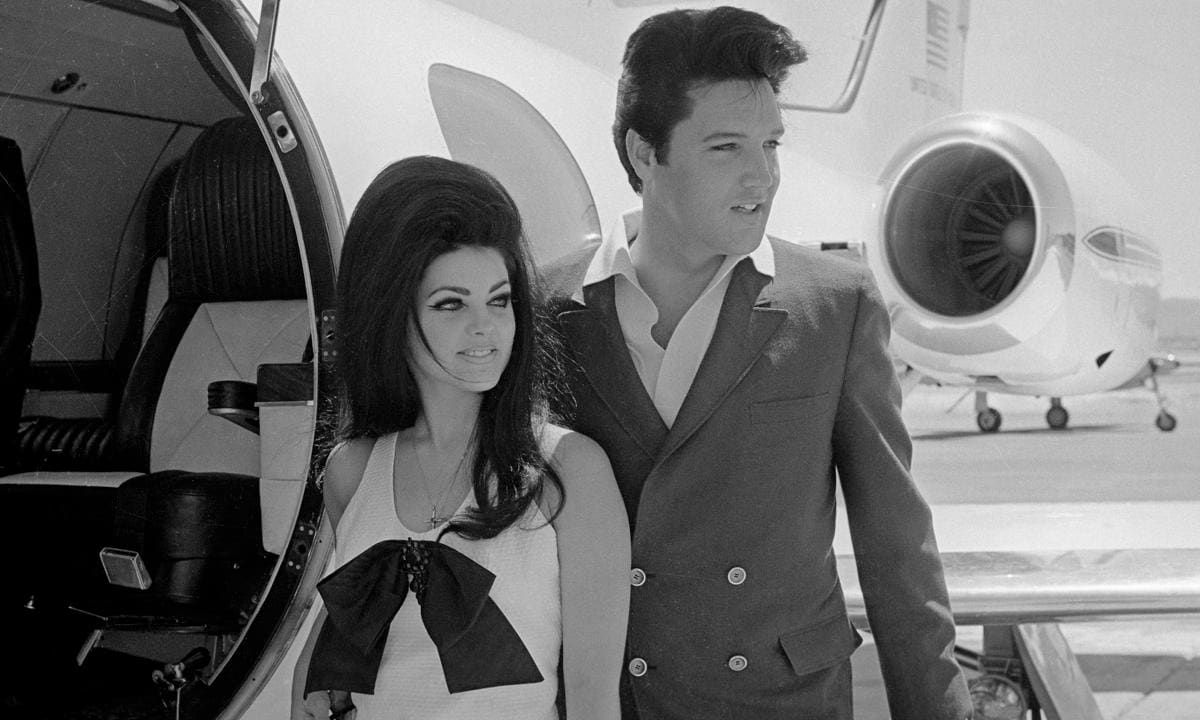 Elvis and Priscilla Presley Posing near Airplane