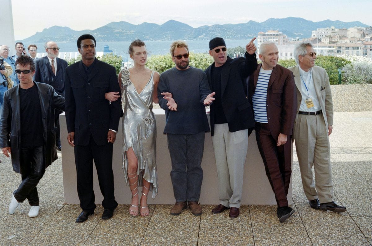 From left, French composer Eric Serra, US actor Chris Tucker, Ukrainian actress Milla Jovovich, French film director Luc Besson, US actor Bruce Willis, French designer Jean-Paul Gaultier and French film producer Patrice Ledoux pose for the presentation of the film "The Fifth Element" during the 50th Cannes Film Festival in Cannes