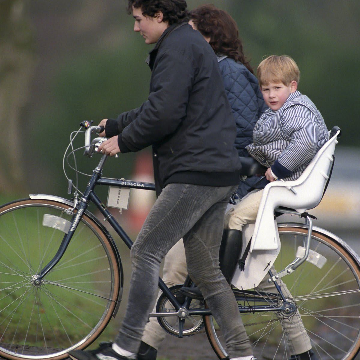 A young Prince Harry was spotted in his baby bike seat in 1990.