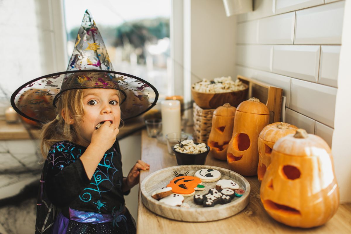 Try serving popcorn in Halloween-themed bowls, making ghost-shaped sandwiches, or decorating cookies with candy eyes.