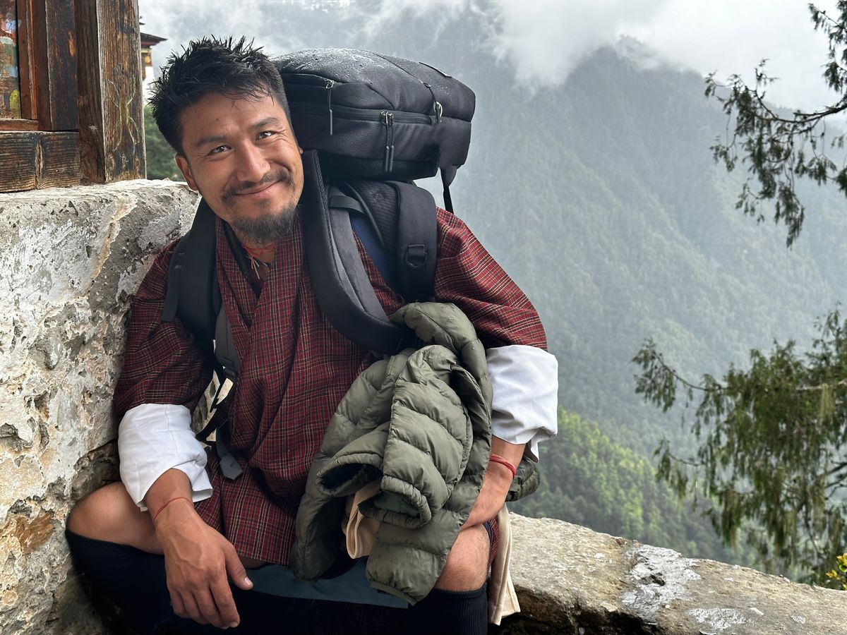 Bhutanese Tour Guide Sitting Resting hiking to Paro Taktsang Monastery in Bhutan