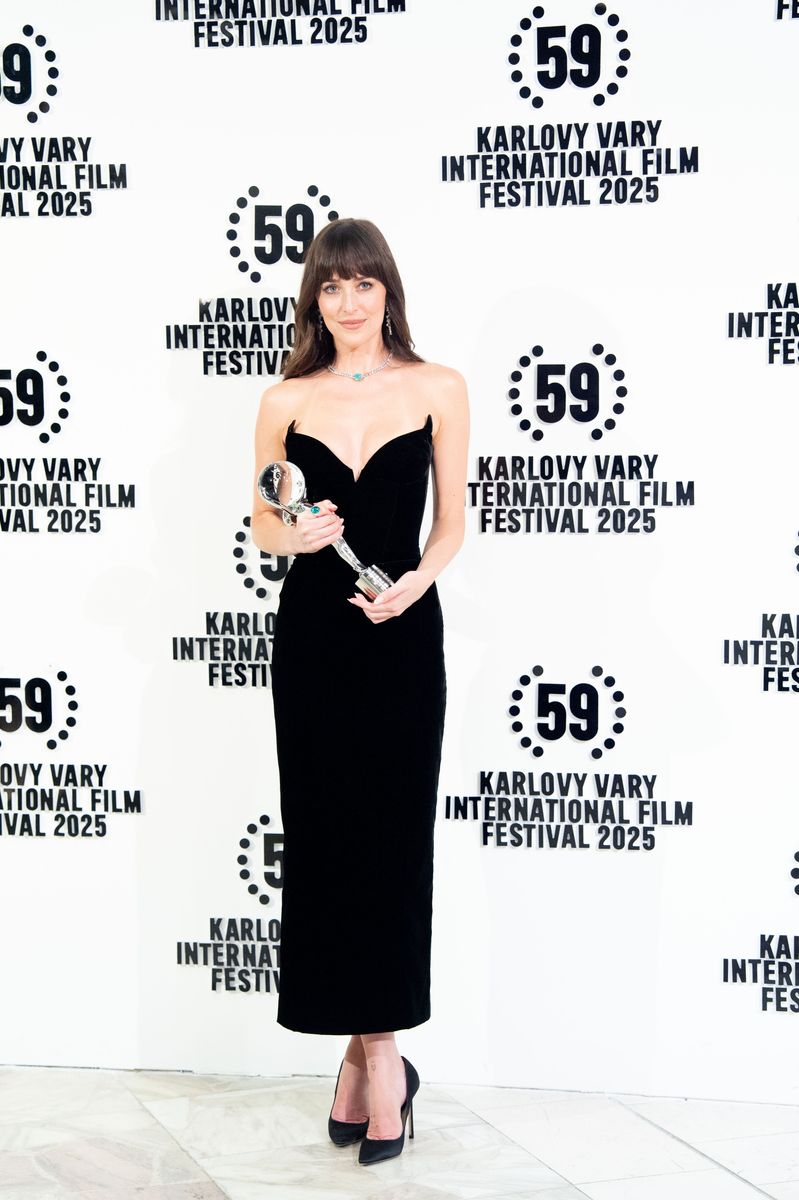Dakota Johnson poses for a photo after receiving the KVIFF President's Award during the 59th Karlovy Vary Film Festival 