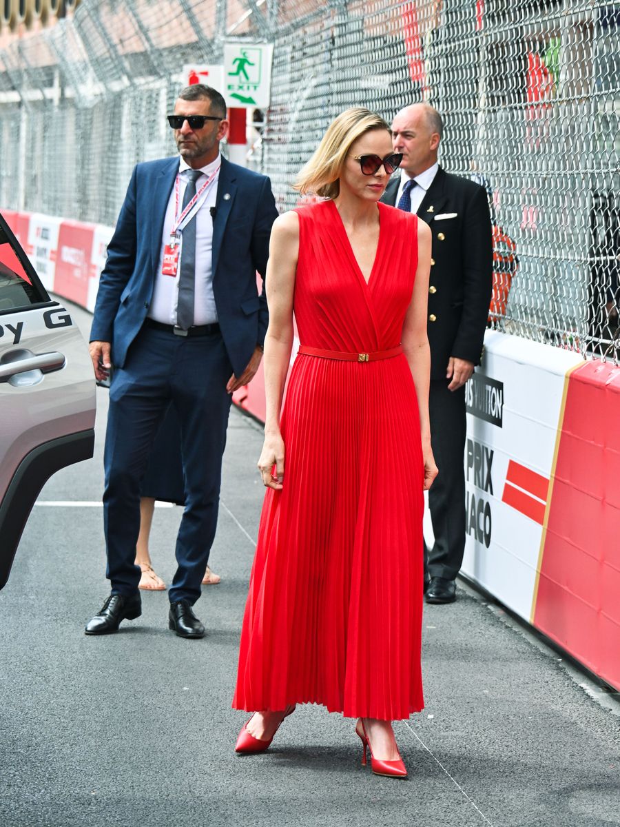 Charlene's bold red ensemble brought a vibrant pop of color to the opening day of Grand Prix festivities.