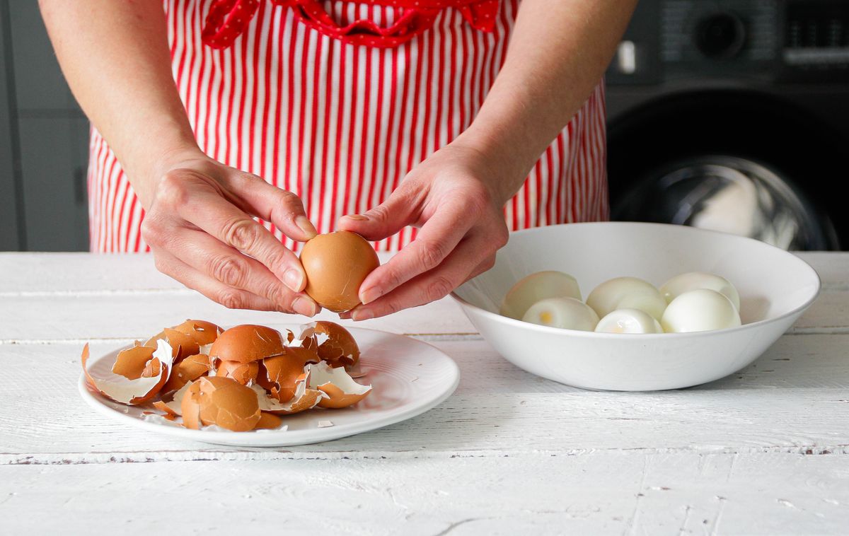 A woman peels eggs