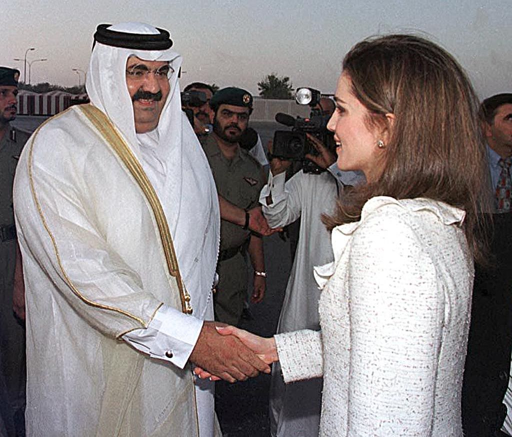 Queen Rania is welcomed by then-Emir Sheikh Hamad bin Khalifa Al Thani upon her arrival in Doha during an official visit to Qatar in November 1999.
