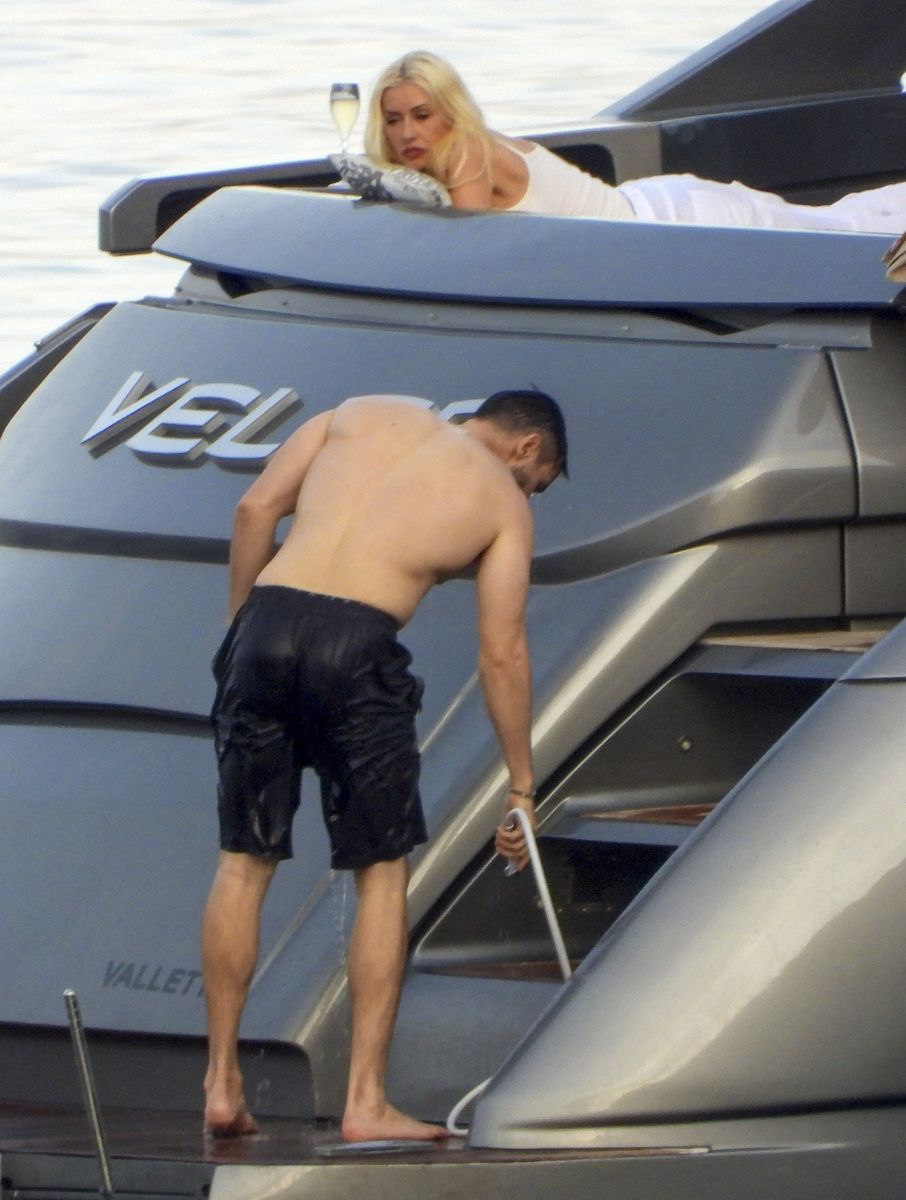 Christina Aguilera and her partner Matthew Rutler relax, sunbathe, sip drinks, and share kisses
