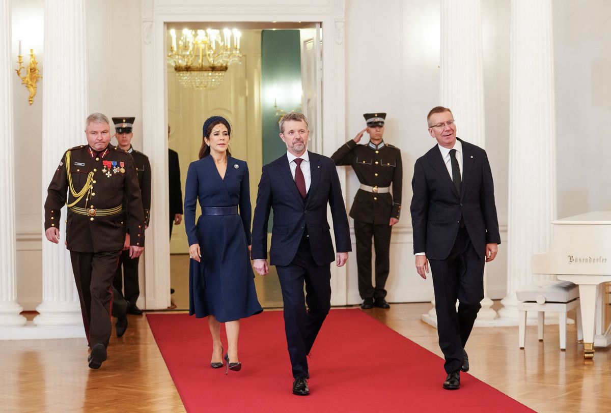 Denmark's King Frederik (C) and Queen Mary and Latvia's President Edgars Rinkevics (R) enter the room to sign the guest book at the presidential residency at Riga Castle on October 28, 2025 at the start of the two-day state visit of the Danish royal couple to Latvia. (Photo by Gints Ivuskans / AFP) (Photo by GINTS IVUSKANS/AFP via Getty Images)