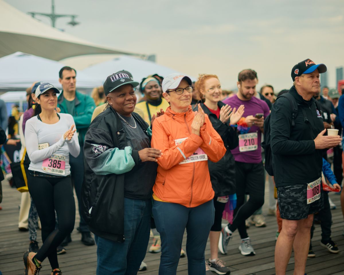 Crowds of between 100-200 people at Pier 45 in Chelsea, New York City gather for the marathon and community building