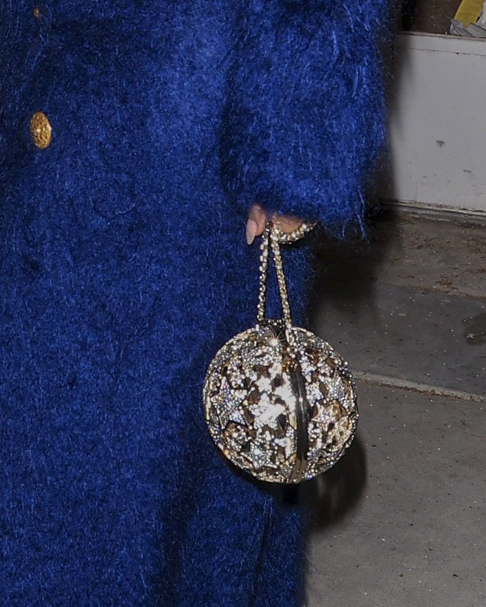 Lauren kept it classy in a navy textured coat and oversized sunglasses. 