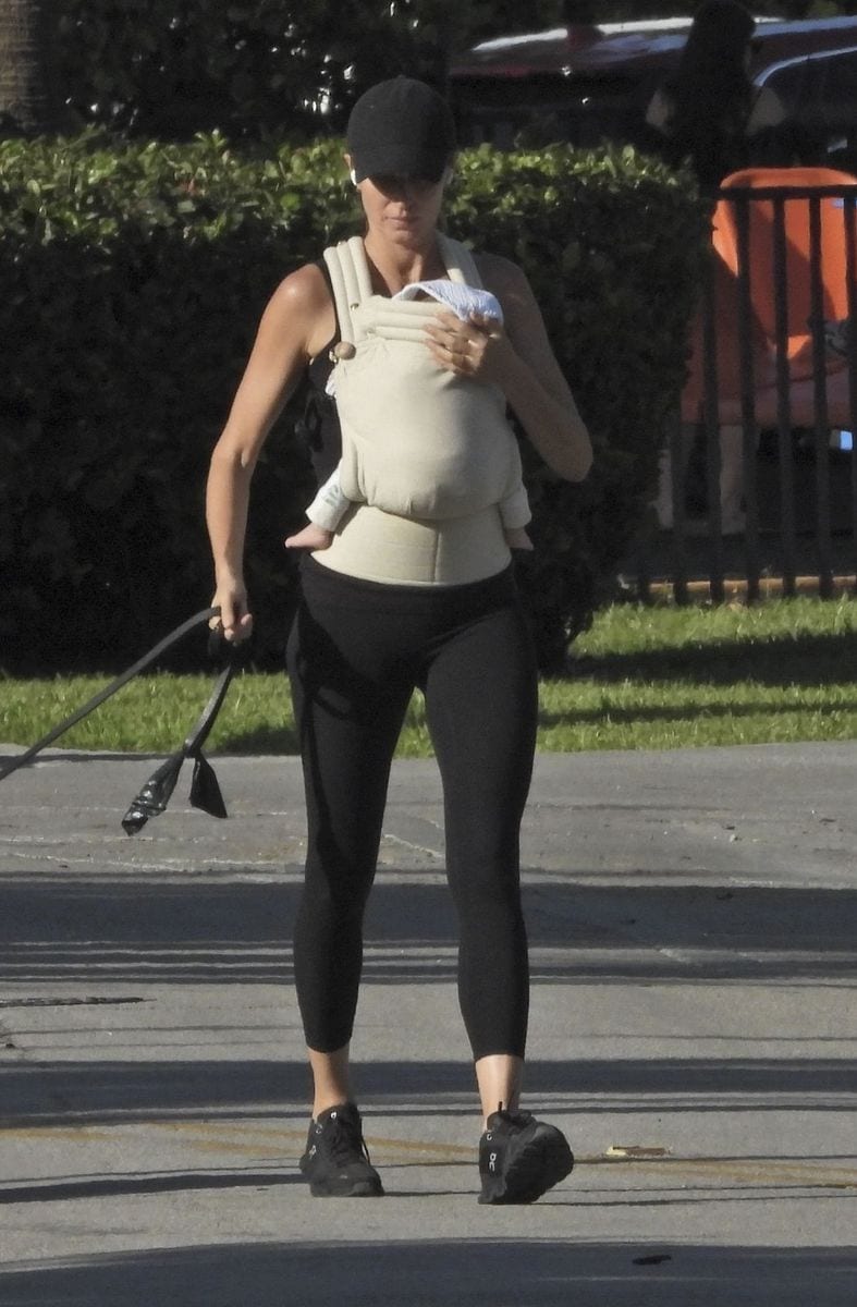 Gisele Bündchen shares a heartwarming moment while strolling through Miami, smiling with joy as she carries her newborn.