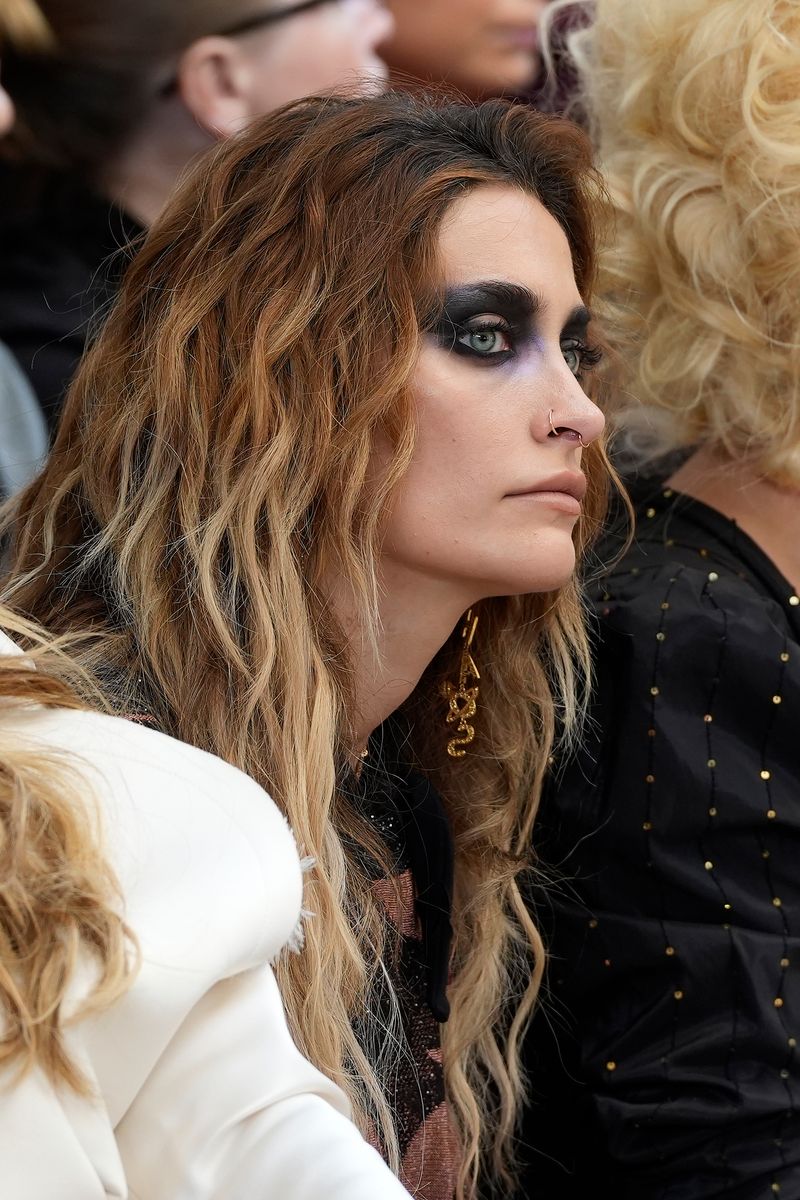 Her complexion appeared natural and softly perfected, while her lips stayed in the nude family.