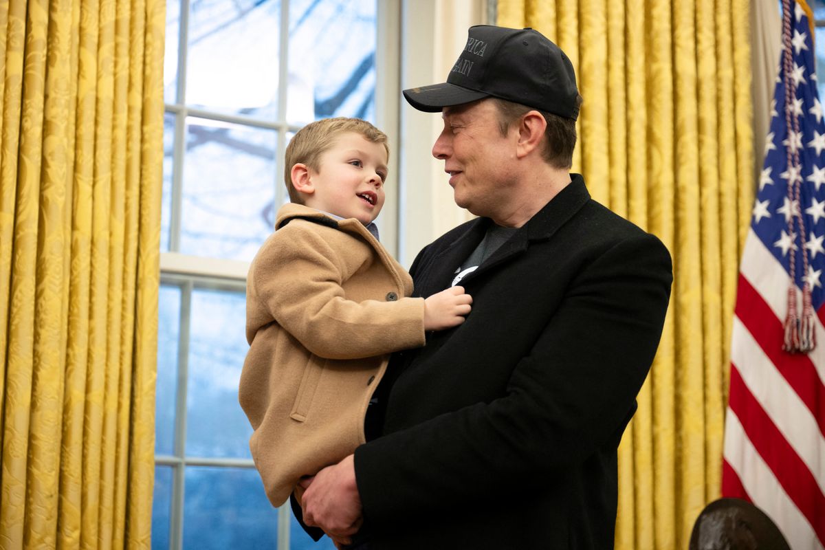 Elon Musk carries his son X in the Oval Office of the White House