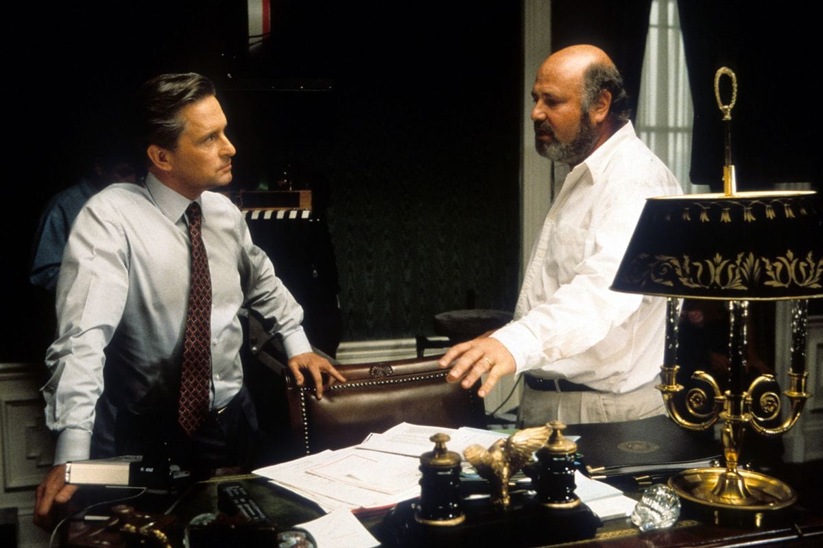 Michael Douglas listening to Director Rob Reiner in between scenes from the film 'The American President'.