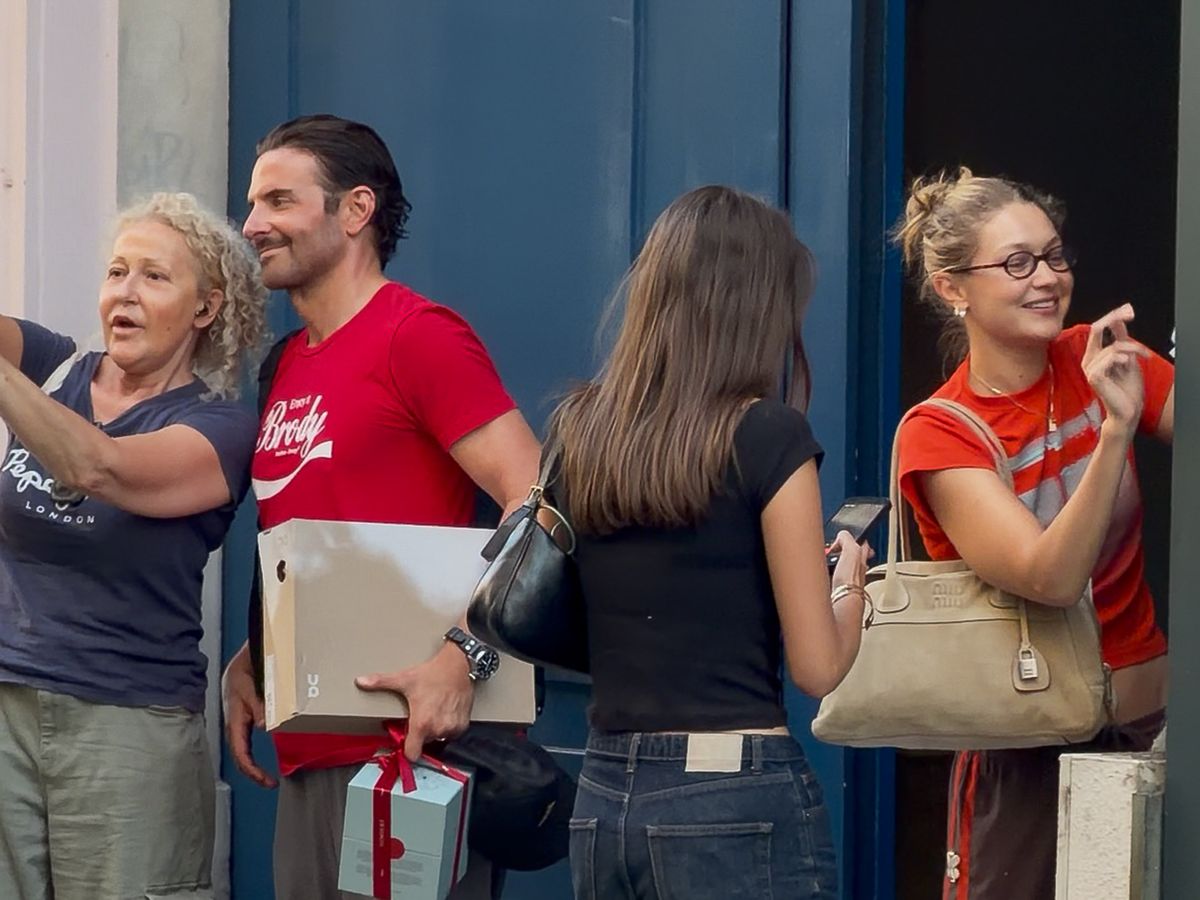 Bradley Cooper and Gigi Hadid wearing coordinated outfits during a stylish daytime outing.