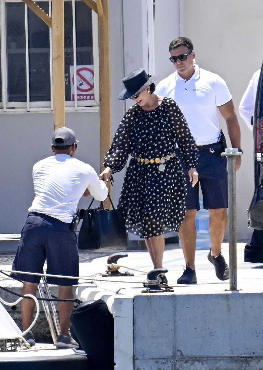 Kris smiling as crew members assisted with her belongings