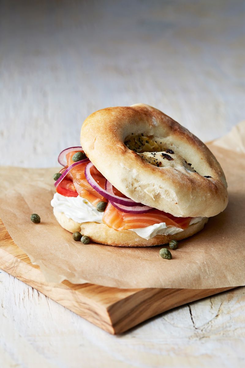 The bagel lox is all about layering smoked salmon with fresh tomato slices, then topping it off with a sprinkle of salt and pepper.

