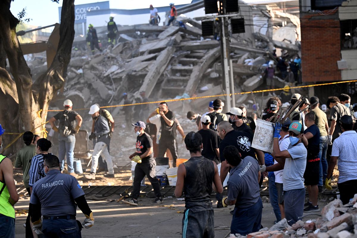 Volunteers and rescuers look for survivors amid the rubble of a collapsed building after an earthquake in Cali, Colombia on August 11, 2026.