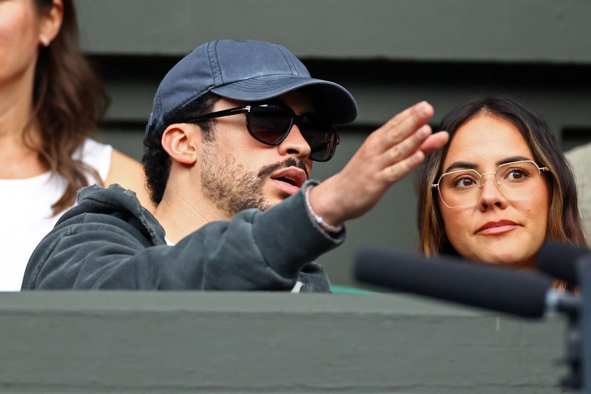 Bad Bunny kept a low profile in a hoodie, cap and sunglasses while Gabriela Berlingeri sat beside him courtside.