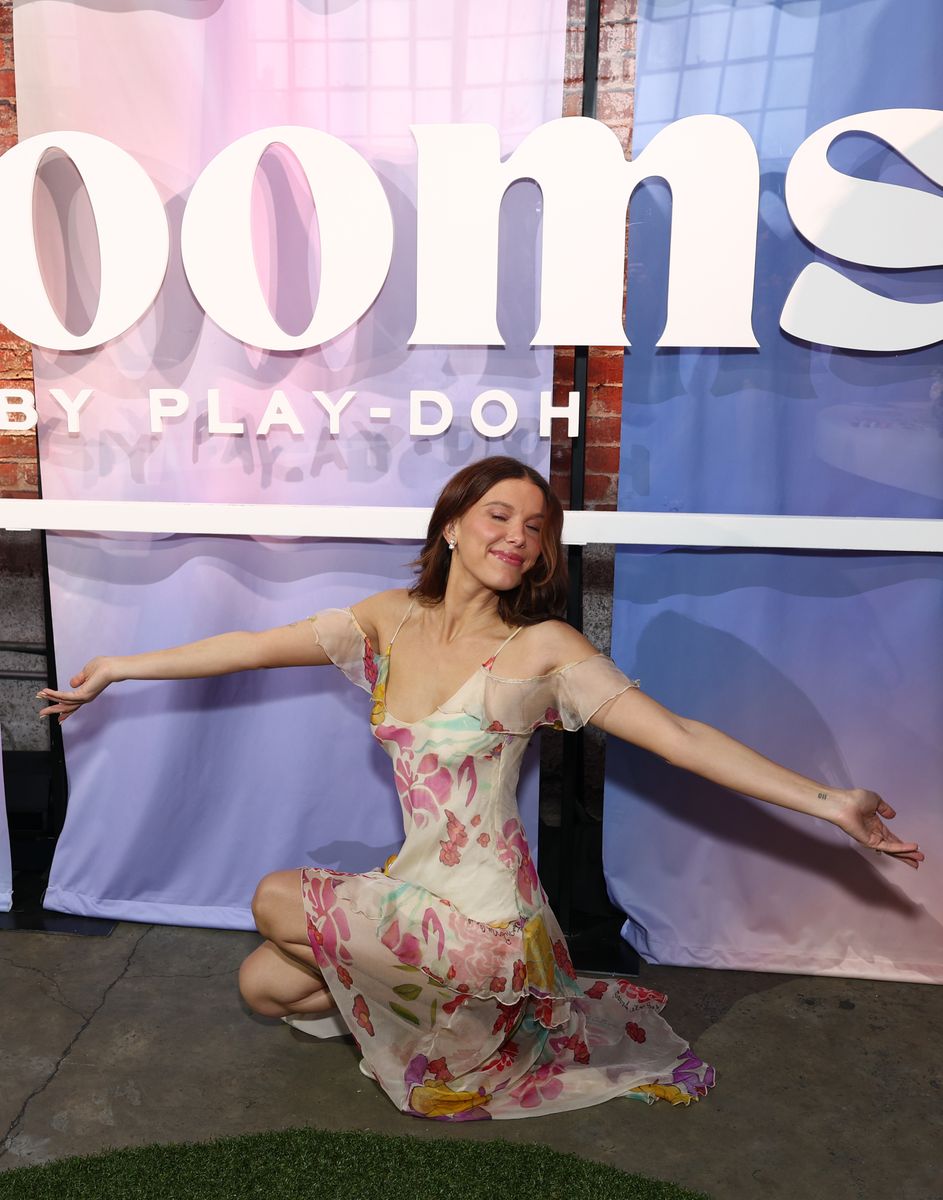 Soft brunette waves and fresh, glowing makeup perfectly complemented Millie Bobby Brown's romantic floral ensemble.