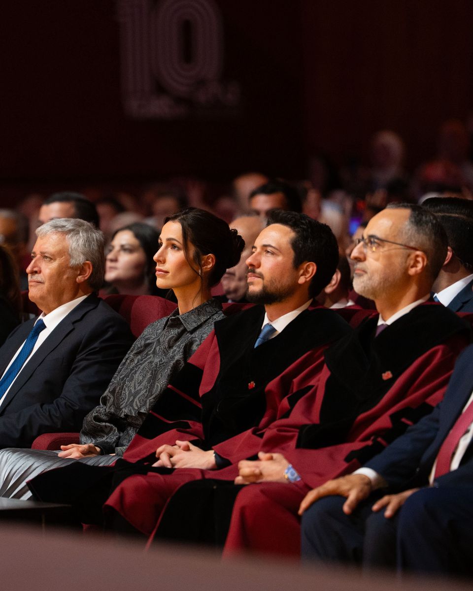 Princess Rajwa of Jordan looked elegant in a fashion-forward grey ensemble featuring an oversized jacquard shirt and shimmering metallic silver pleated skirt as she joined Crown Prince Hussein for the Al Hussein Technical University graduation ceremony in Amman.
