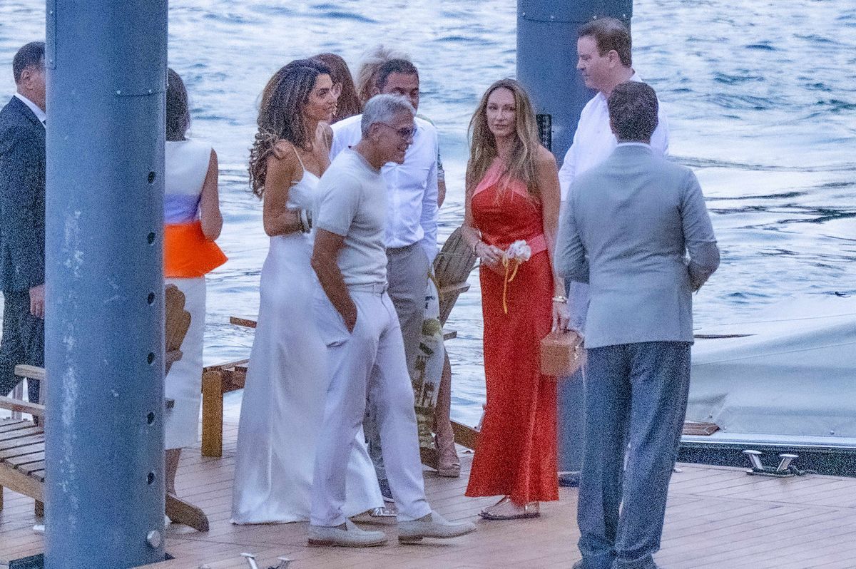 George complemented his wife’s all-white look in a fitted T-shirt, pale trousers and casual shoes.