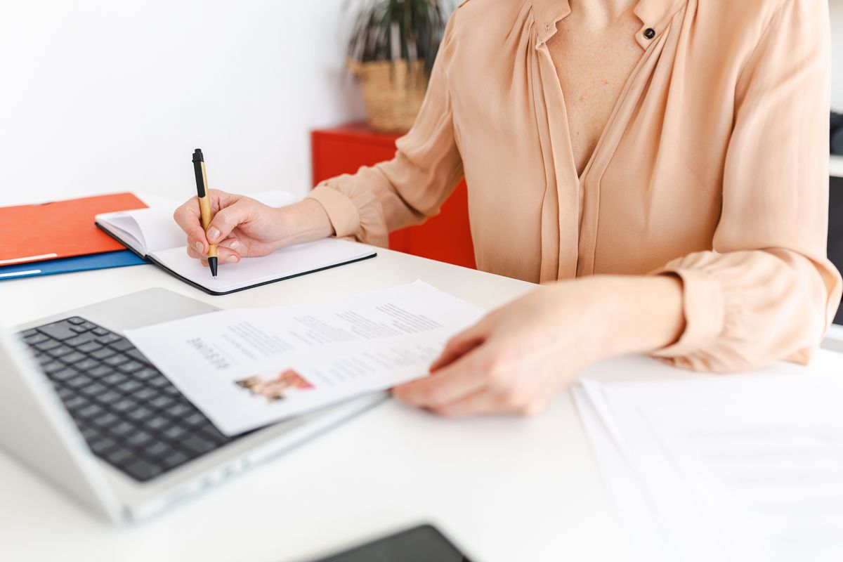 HR woman checking out resumes and working