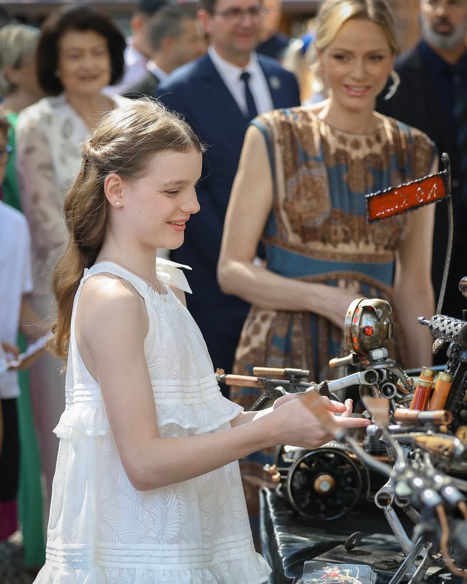 Princess Gabriella looked charming in a white tiered summer dress styled with pearl earrings and gold sandals.