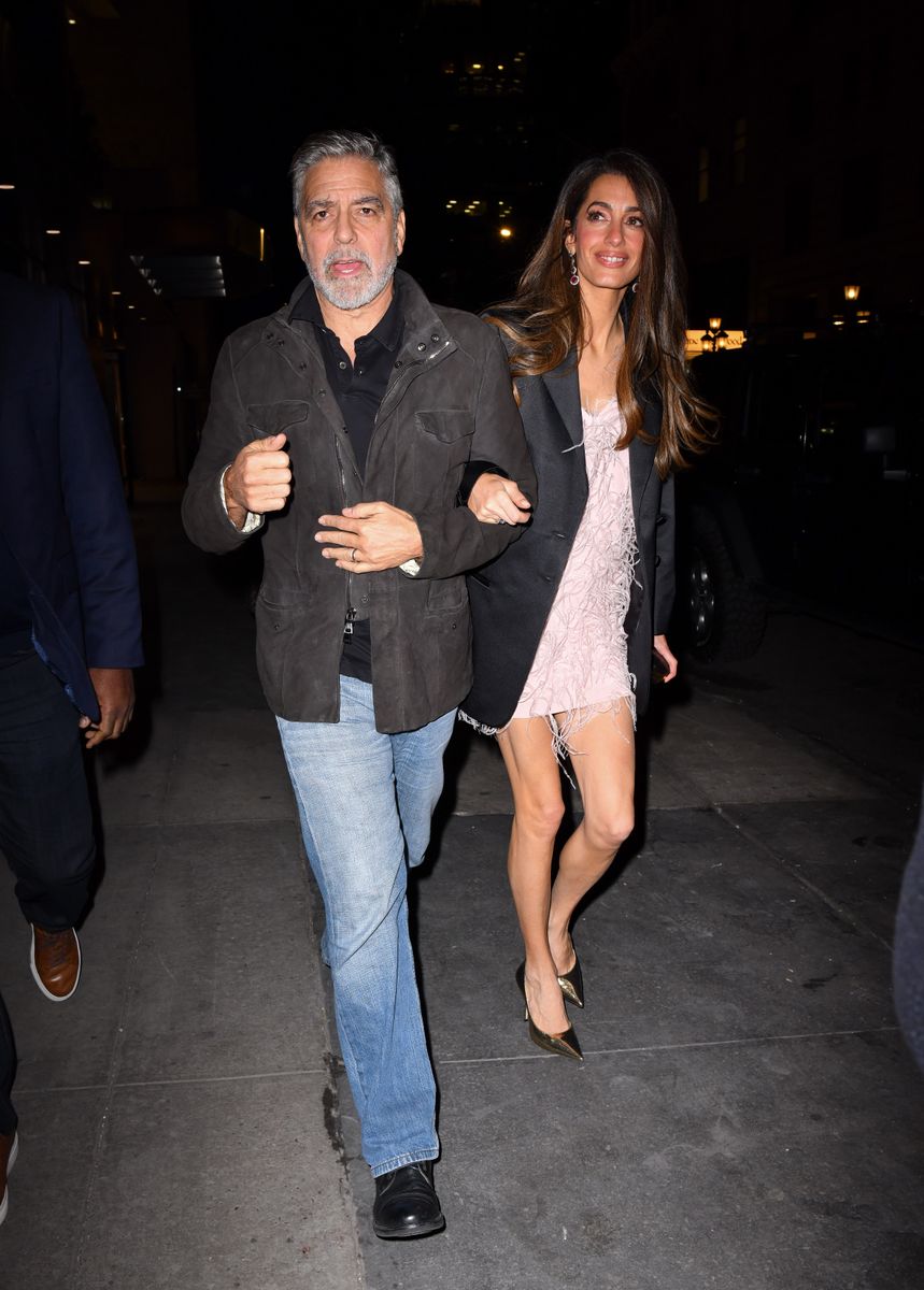 Amal Clooney showed how she takes a leg-baring look into colder weather during a December 2023 date night with George Clooney at the Polo Bar in New York City, layering a sleek black blazer over a white mini dress.