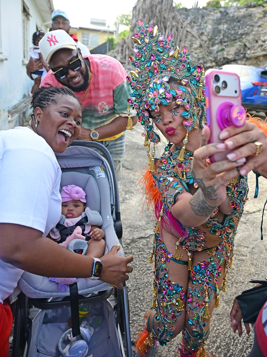  The artist wore a jewel-encrusted carnival costume complete with gemstones and a headpiece while dancing in the streets during the event.