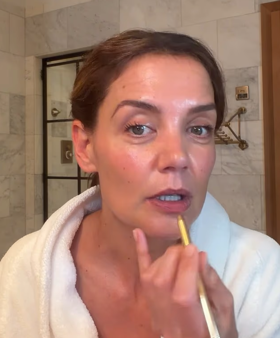 The star, dressed in a white terrycloth robe and makeup-free face, walked viewers through her low-key beauty process while applying concealer, foundation, blush, lip liner, and gloss.